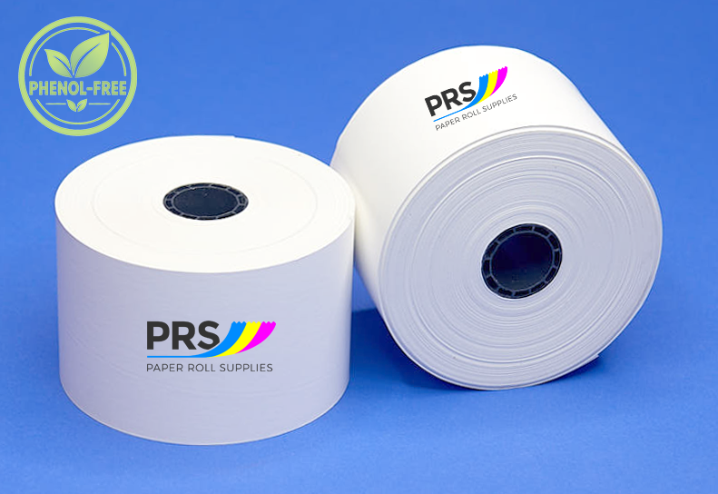Two white PRS paper roll supplies on a blue background, one standing upright and one lying on its side, with a green 'PHENOL-FREE' badge in the top-left corner.